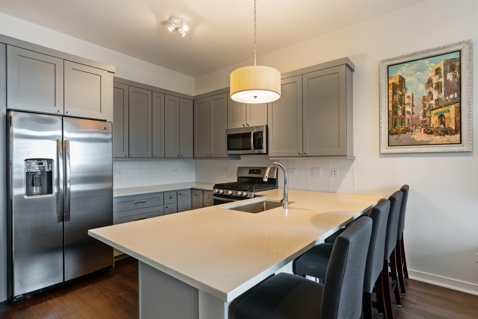 340 West Superior Street, Unit 910 Chicago, IL 60654 - Photo 4 of 10 a kitchen with a table chairs refrigerator and microwave