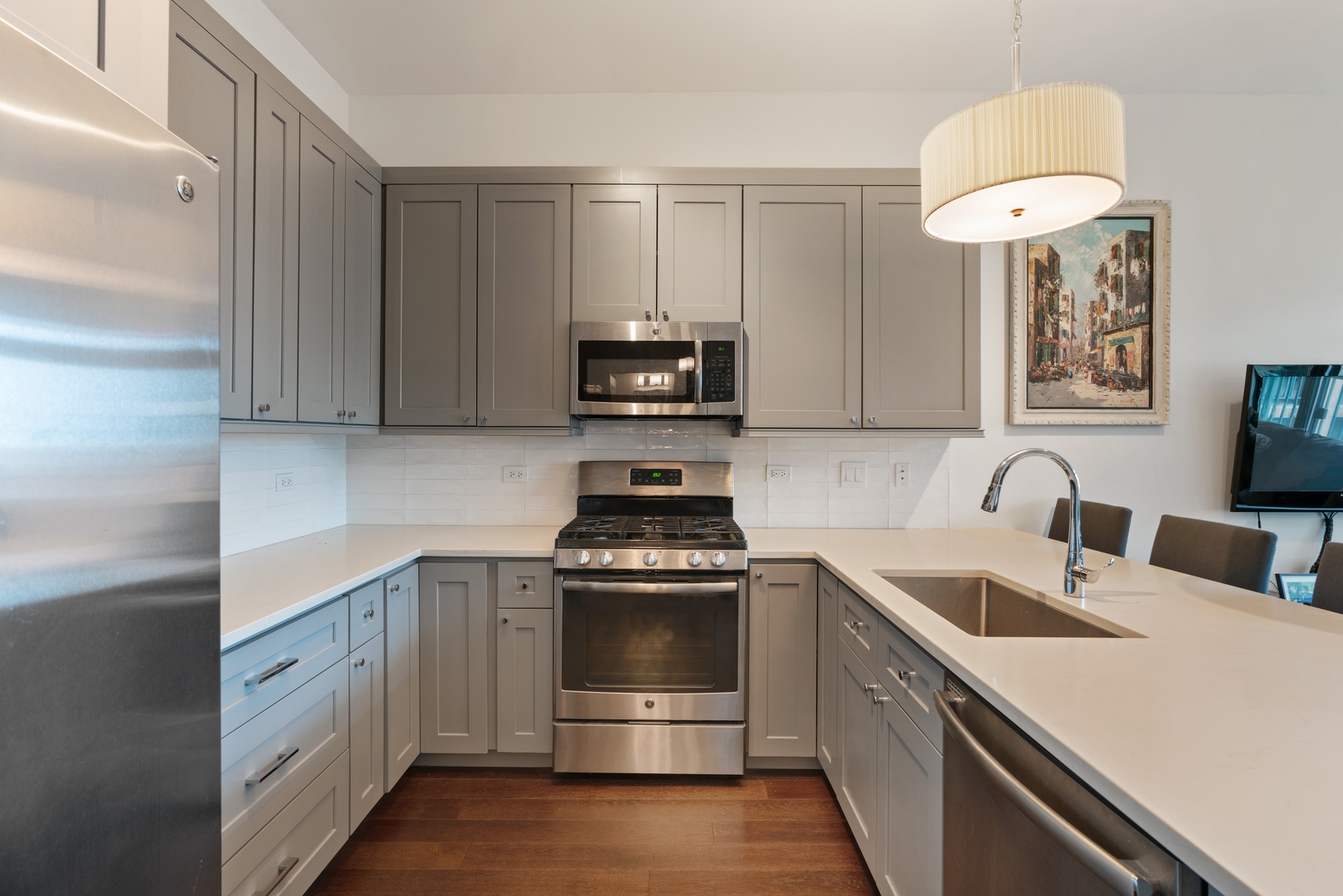 340 West Superior Street, Unit 910 Chicago, IL 60654 - Photo 5 of 10 a kitchen with a stove and a sink