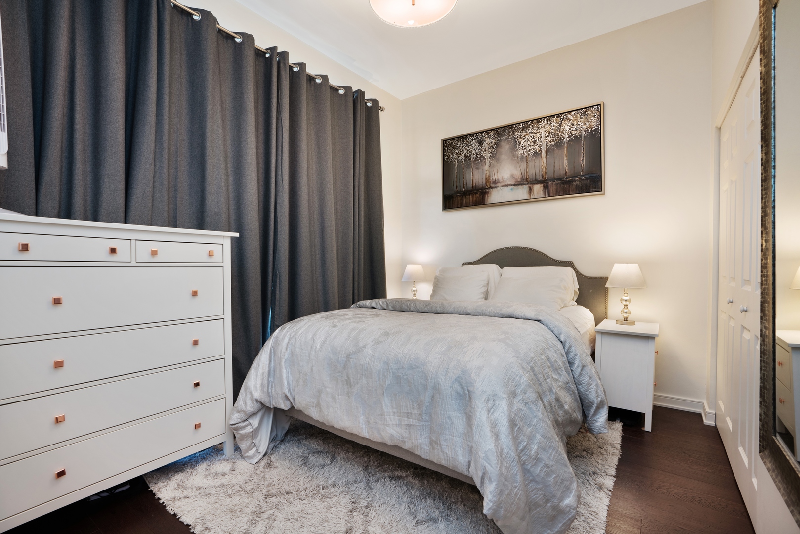 340 West Superior Street, Unit 910 Chicago, IL 60654 - Photo 6 of 10 a bedroom with a bed and a cabinet