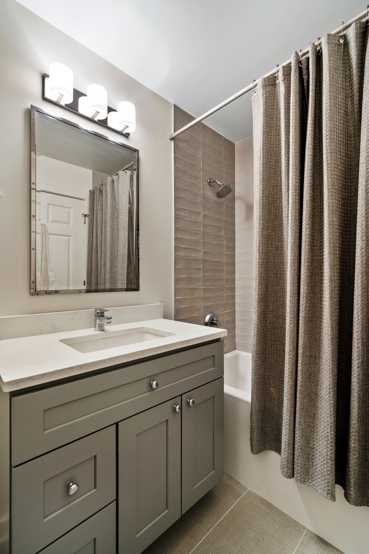 340 West Superior Street, Unit 910 Chicago, IL 60654 - Photo 7 of 10 a bathroom with a double vanity sink and a mirror