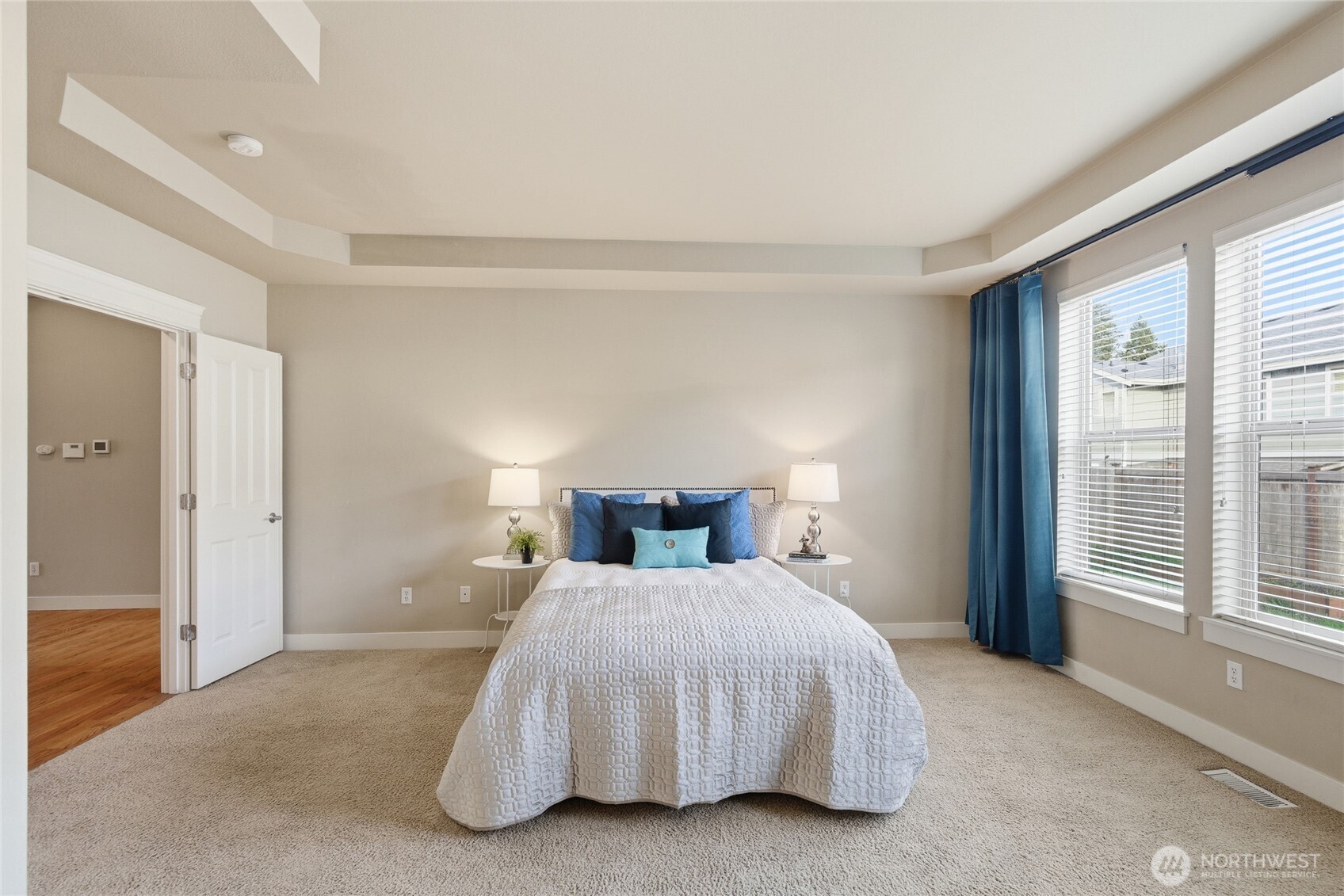 4510 McKinley Street Northeast Lacey, WA 98516 - Photo 13 of 34 a bedroom with a bed and large windows