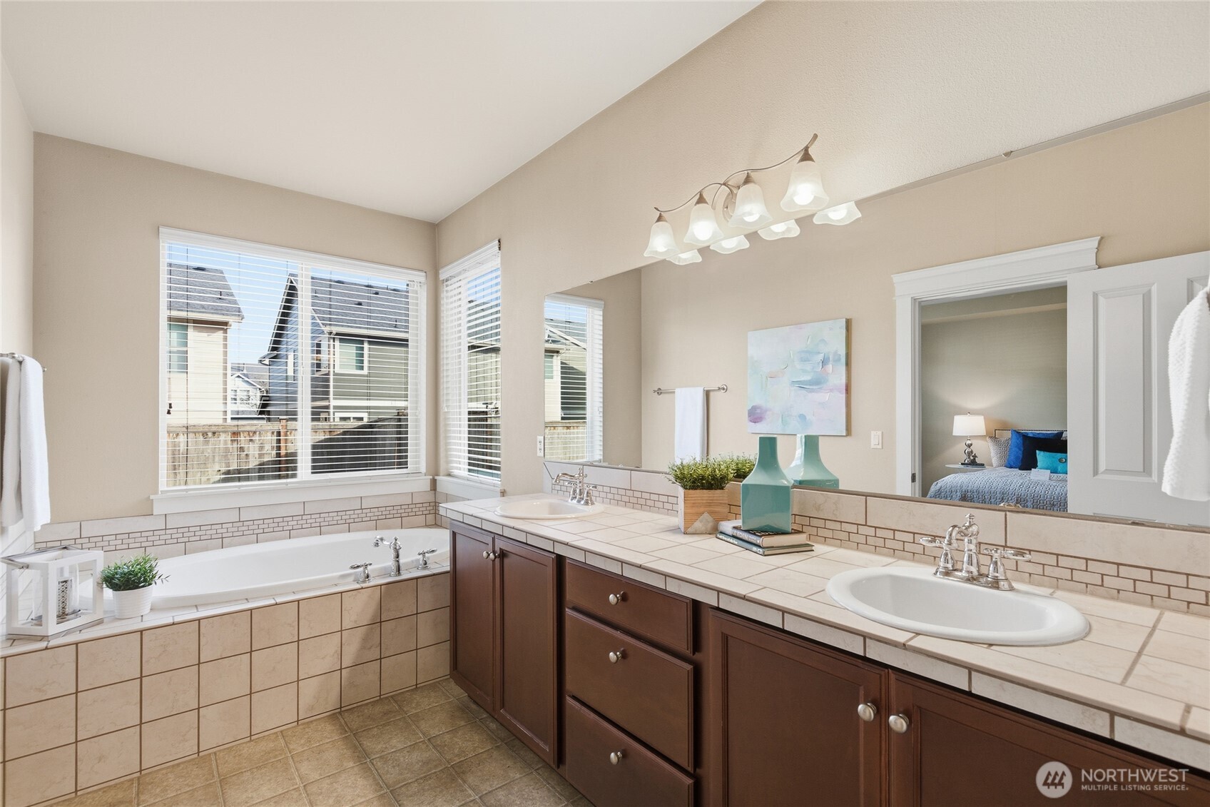 4510 McKinley Street Northeast Lacey, WA 98516 - Photo 15 of 34 a spacious bathroom with a granite countertop double vanity sink a large mirror and a bathtub
