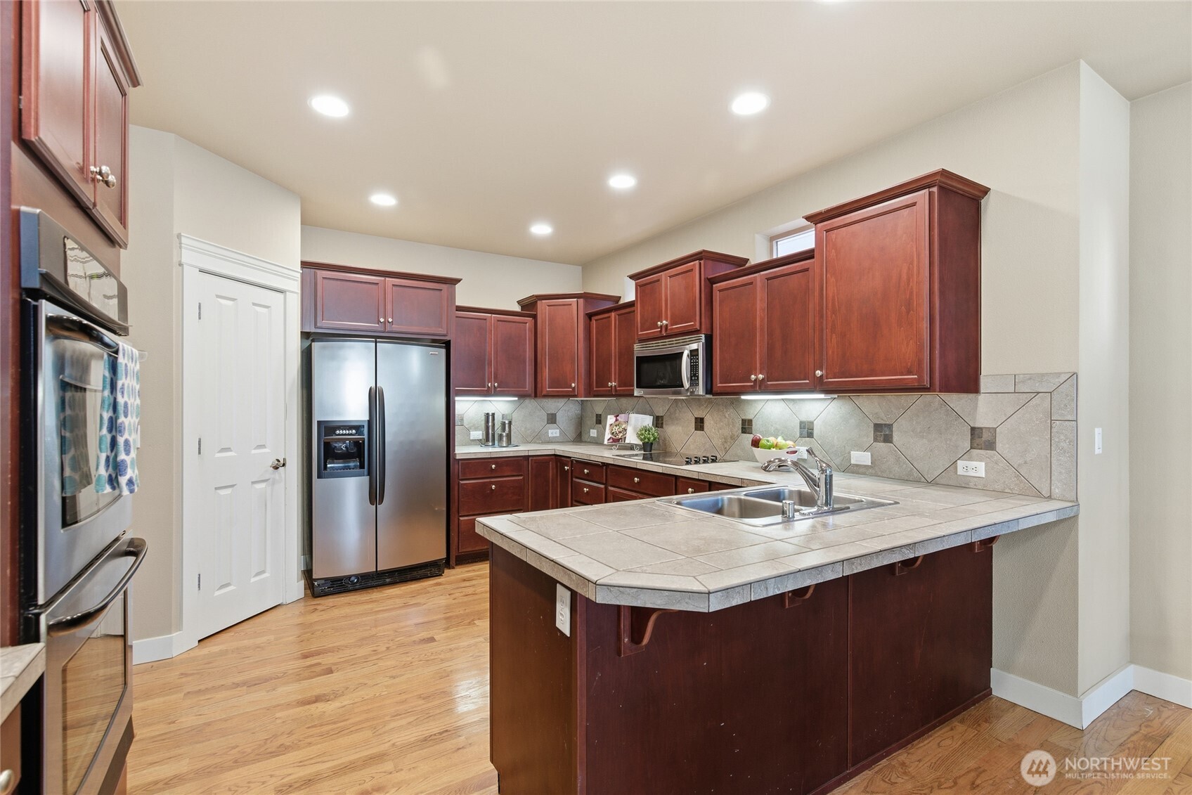 4510 McKinley Street Northeast Lacey, WA 98516 - Photo 7 of 34 a kitchen with a sink refrigerator and cabinets