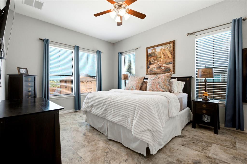 600 Aspen Street Pilot Point, TX 76258 - Photo 8 of 39 Room featuring light gray walls, multiple windows with horizontal blinds, and wood-finish flooring