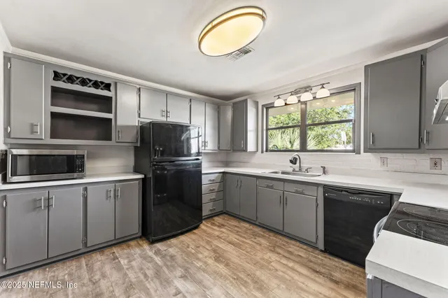 a kitchen with a sink stove and microwave