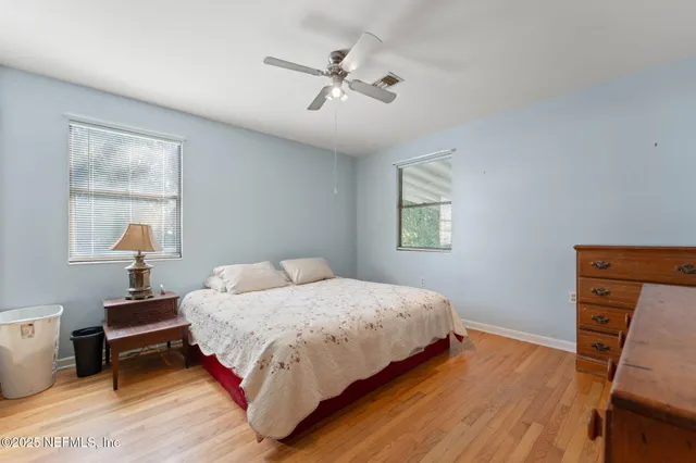 a bedroom with a bed and a tv on the dresser