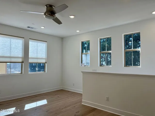 a view of a kitchen with white cabinets