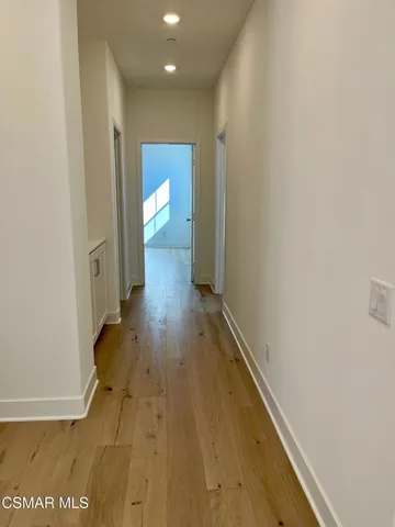 a view of a room with wooden floor and windows