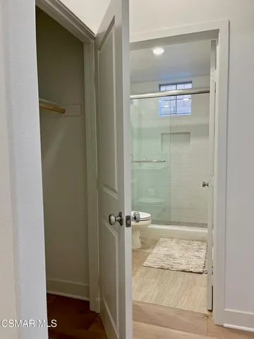 a bathroom with a glass shower door