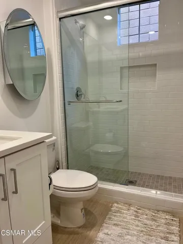 a bathroom with a toilet and a shower