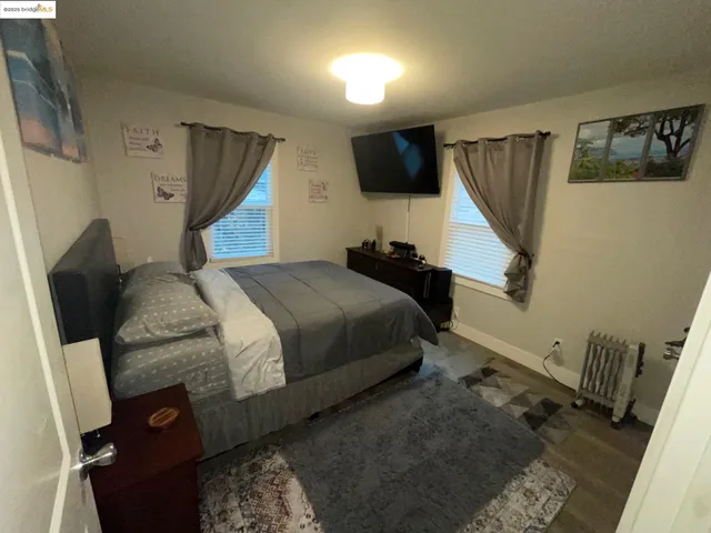 a bedroom with a bed and flat screen tv
