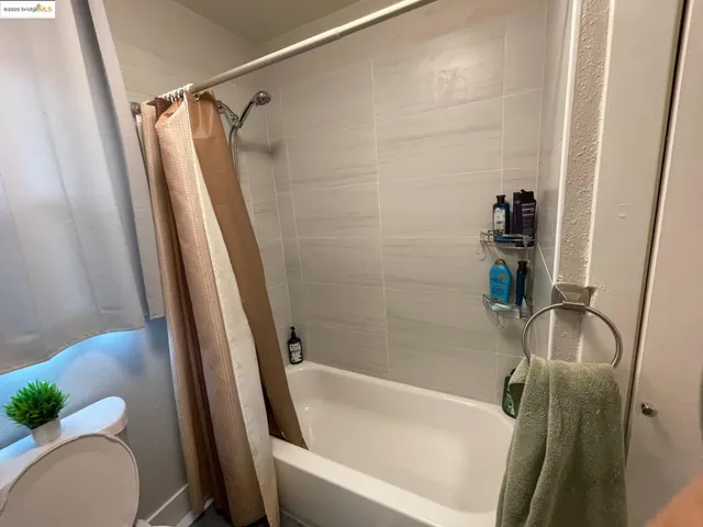 a bathroom with a tub and a shower