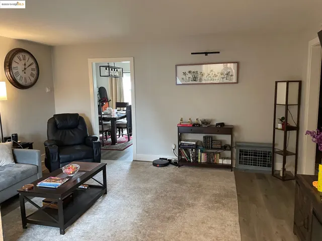 a living room with furniture a air conditioner and a window