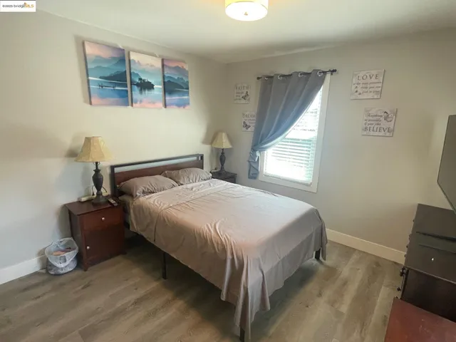 a bedroom with a bed and window