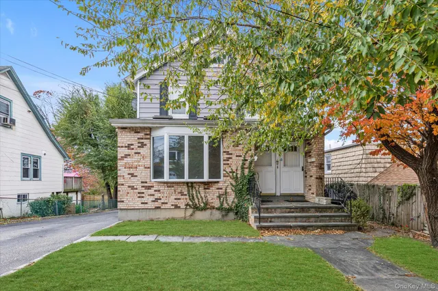 a front view of a house with a garden
