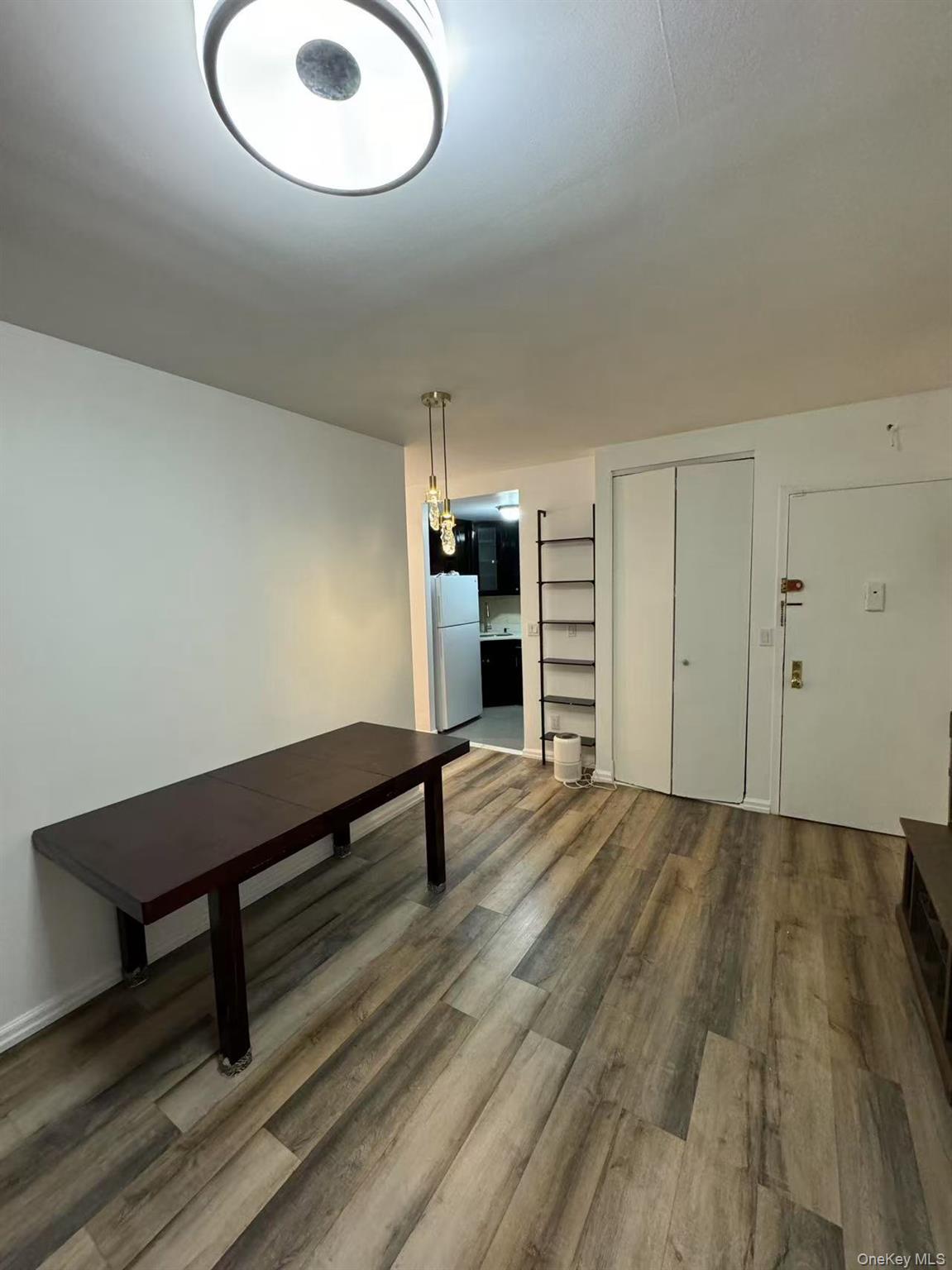 38-08 147th Street, Unit C2 Queens, NY 11357 - Photo 4 of 12 a room with wooden floor and window