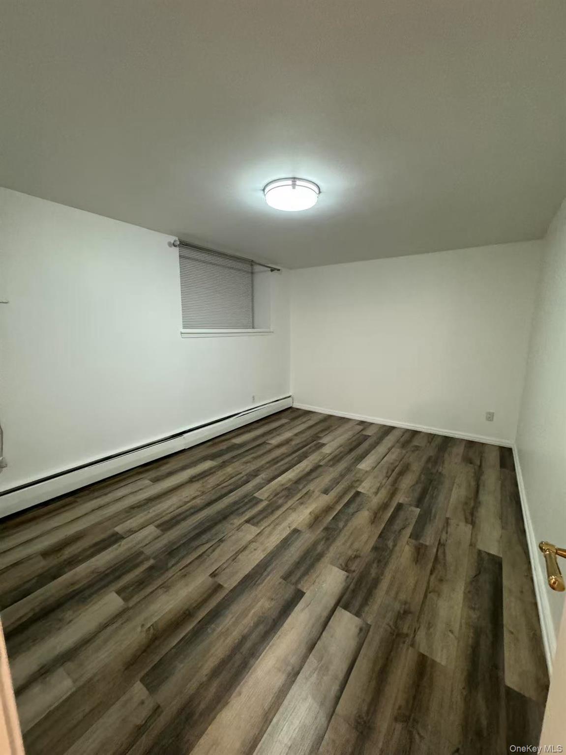 38-08 147th Street, Unit C2 Queens, NY 11357 - Photo 8 of 12 en empty room with wooden floor