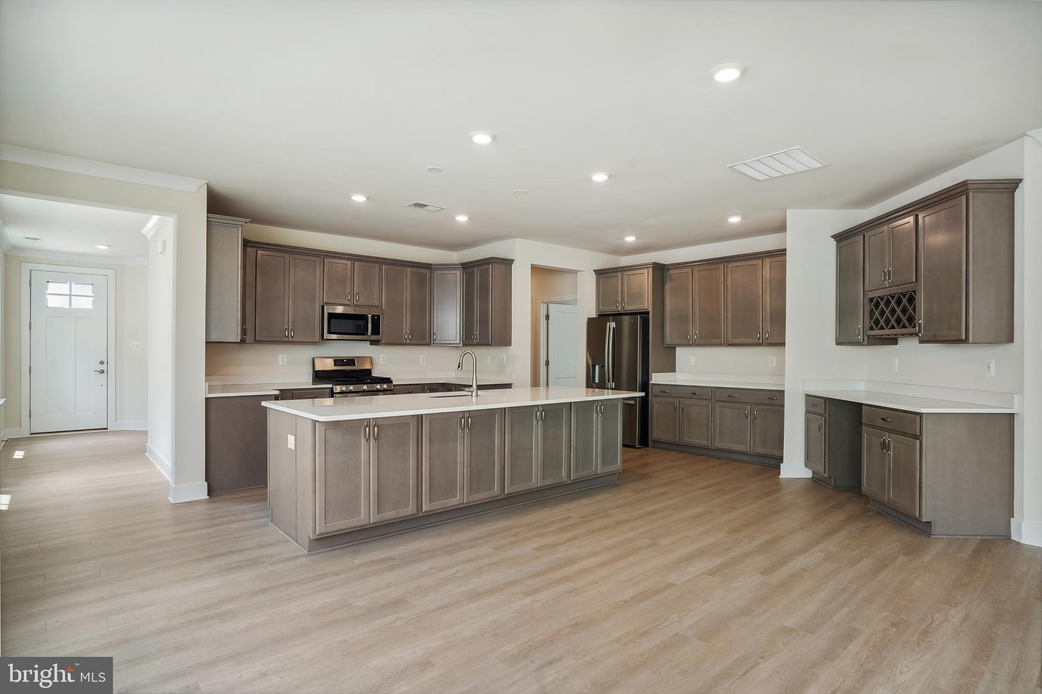 19 Cardinal Flower Way Gettysburg, PA 17325 - Photo 8 of 34 a kitchen with stainless steel appliances kitchen island granite countertop a stove a sink and a refrigerator