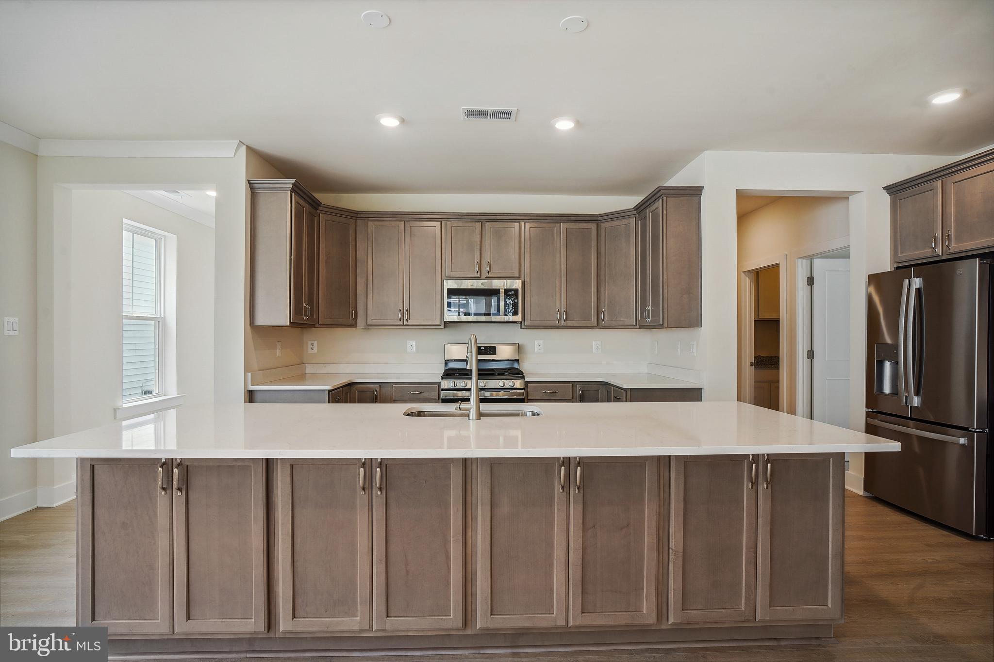 19 Cardinal Flower Way Gettysburg, PA 17325 - Photo 9 of 34 a kitchen with kitchen island granite countertop a refrigerator oven a sink and dishwasher