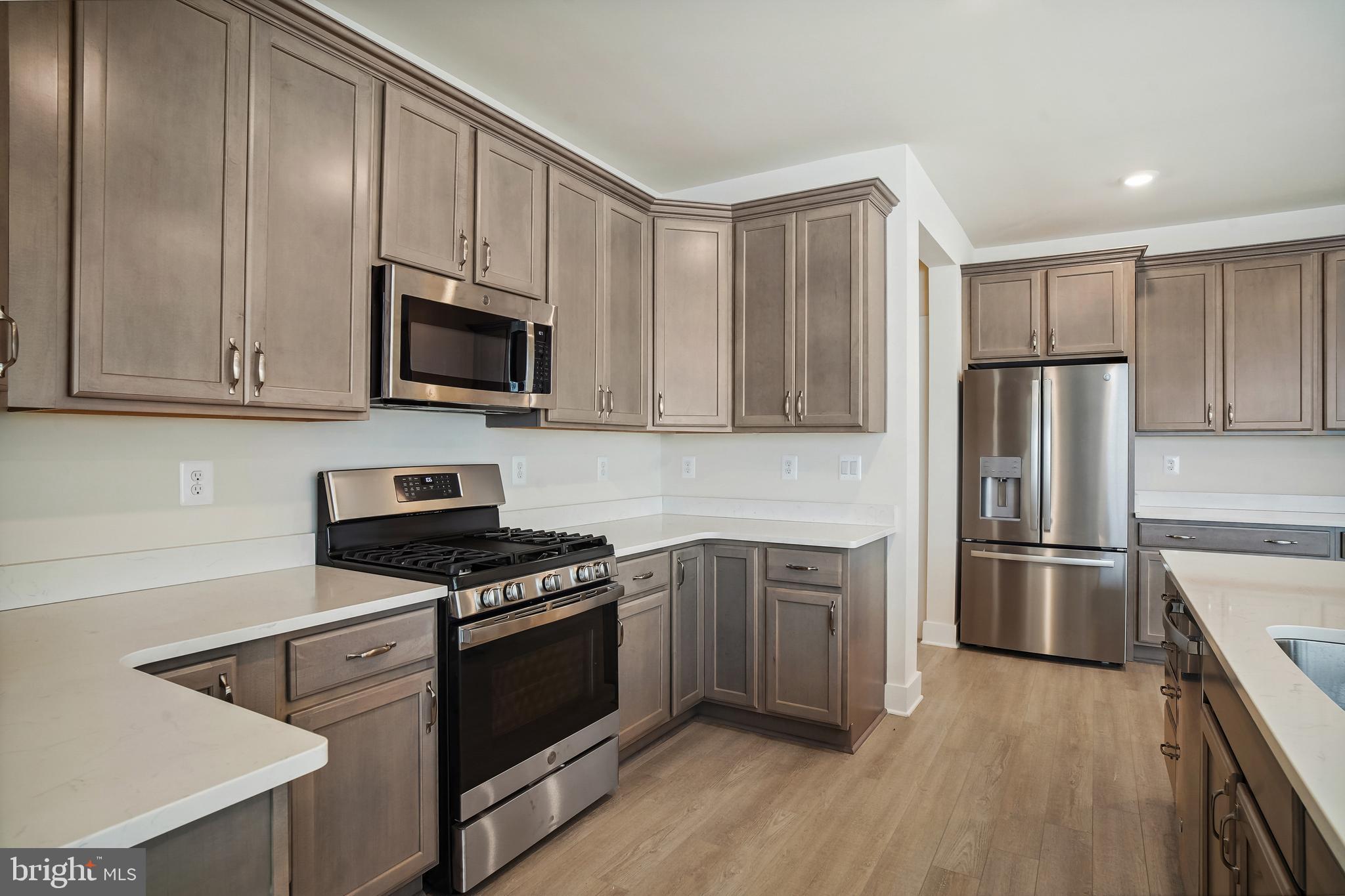 19 Cardinal Flower Way Gettysburg, PA 17325 - Photo 10 of 34 a kitchen with cabinets stainless steel appliances and wooden floor