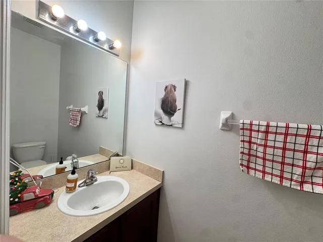a bathroom with a sink vanity and a mirror