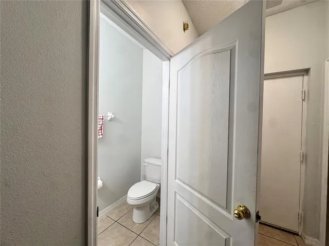 a bathroom with a granite countertop toilet and a shower