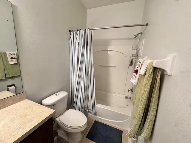 a white toilet sitting next to a bathroom sink