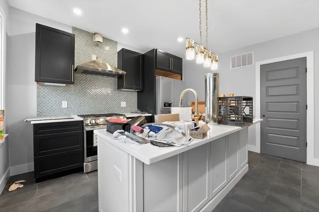 a kitchen with a stove and a sink