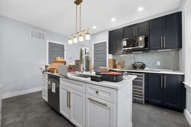 a kitchen with stainless steel appliances granite countertop a stove and a refrigerator