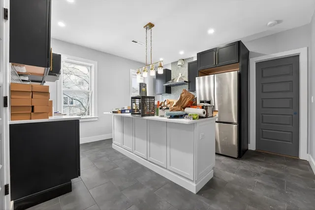 a kitchen that has a lot of cabinets in it