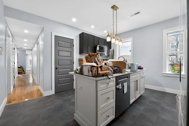 a kitchen with stainless steel appliances granite countertop a stove and a sink
