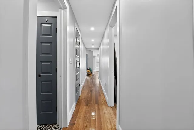 a room with wooden floor and a bed