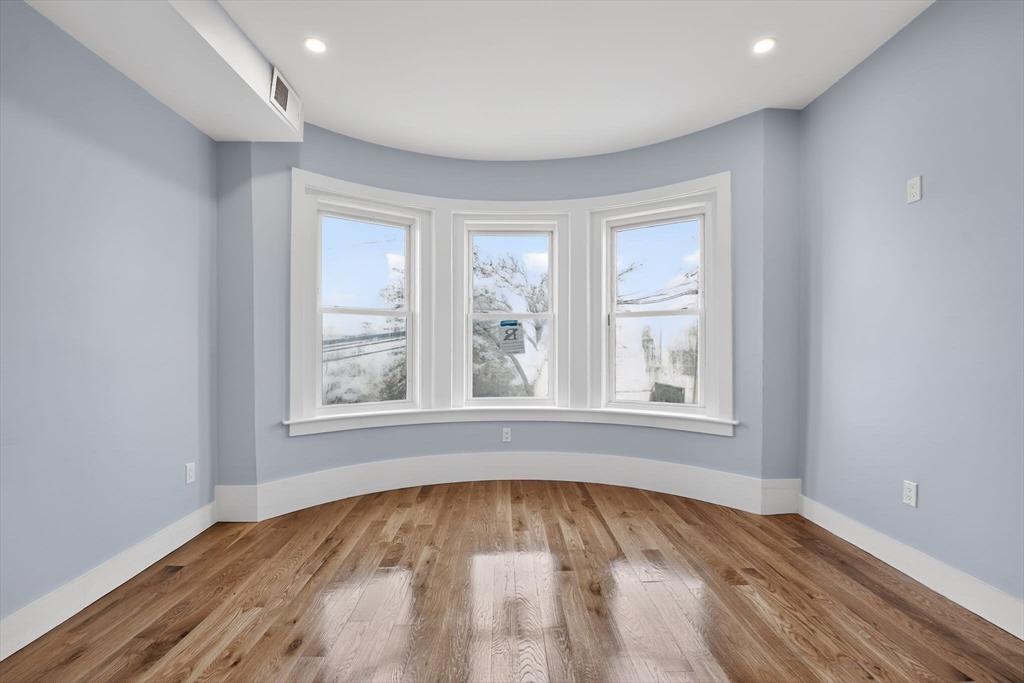 31 Homestead Street, Unit 2 Boston, MA 02121 - Photo 4 of 23 an empty room with wooden floor and windows