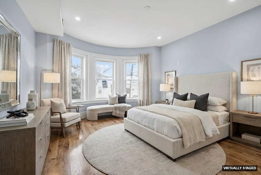 31 Homestead Street, Unit 2 Boston, MA 02121 - Photo 5 of 23 a bedroom with a bed and large windows