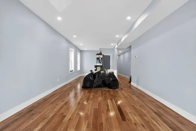 a room with a bed and wooden floor
