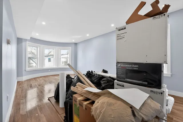 a view of a small space with wooden floor and a window