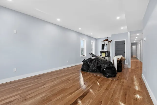 a view of a livingroom with wooden floor and a window