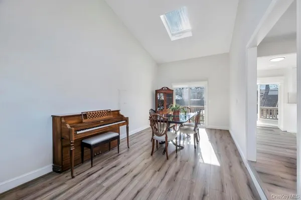 a dining room with furniture and wooden floor