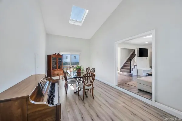 a dining room with furniture and wooden floor