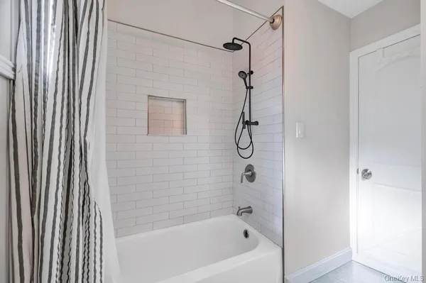 a bathroom with a bath tub and shower