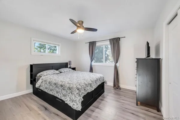 a bedroom with bed and window