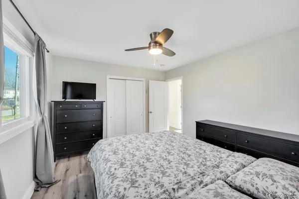 a bedroom with a bed and a television