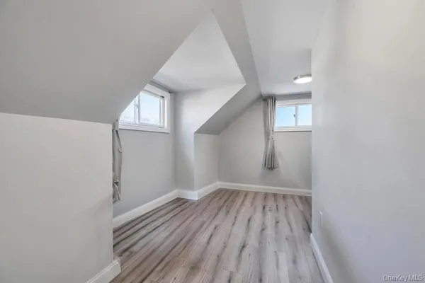 a view of room with window and hardwood floor