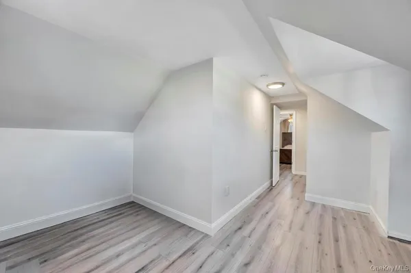 a view of a room with wooden floor and brick walls
