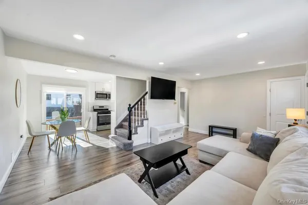 a living room with furniture and wooden floor