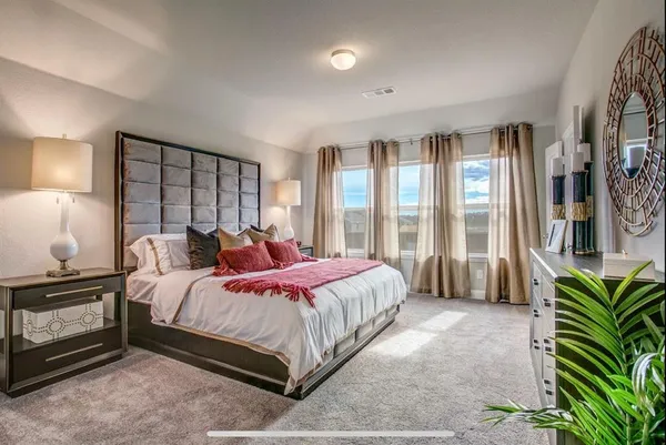 a bed sitting in a bedroom next to a window