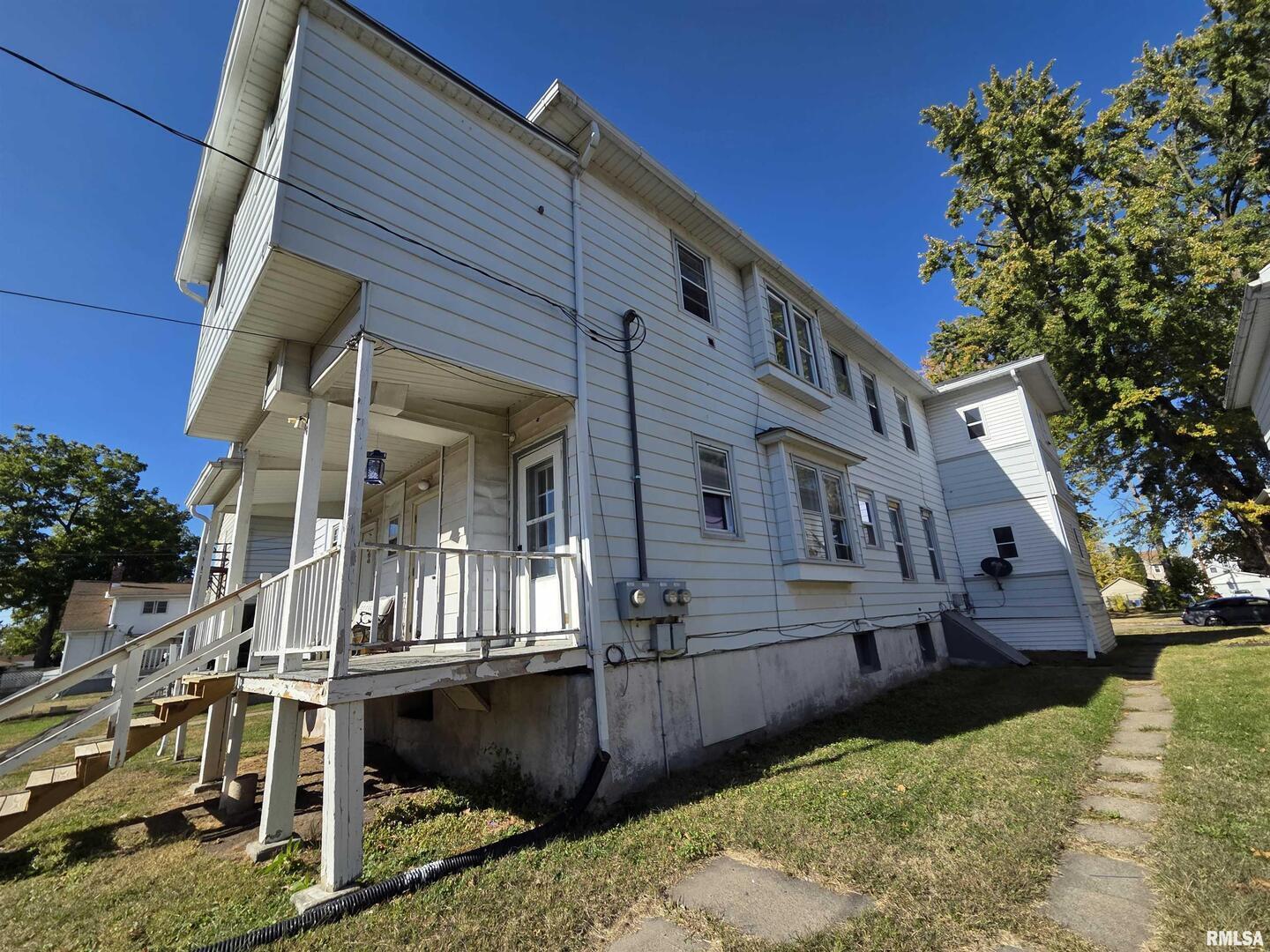 519 4th Avenue South Clinton, IA 52732 - Photo 2 of 16 a front view of a house with a yard