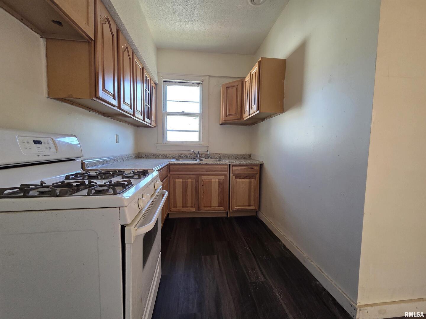 519 4th Avenue South Clinton, IA 52732 - Photo 10 of 16 a kitchen with a stove and a refrigerator