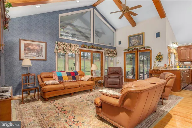 a kitchen with stainless steel appliances granite countertop a stove a sink dishwasher and cabinets with wooden floor