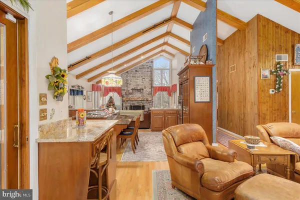 a view of a dining room with furniture a chandelier and wooden floor